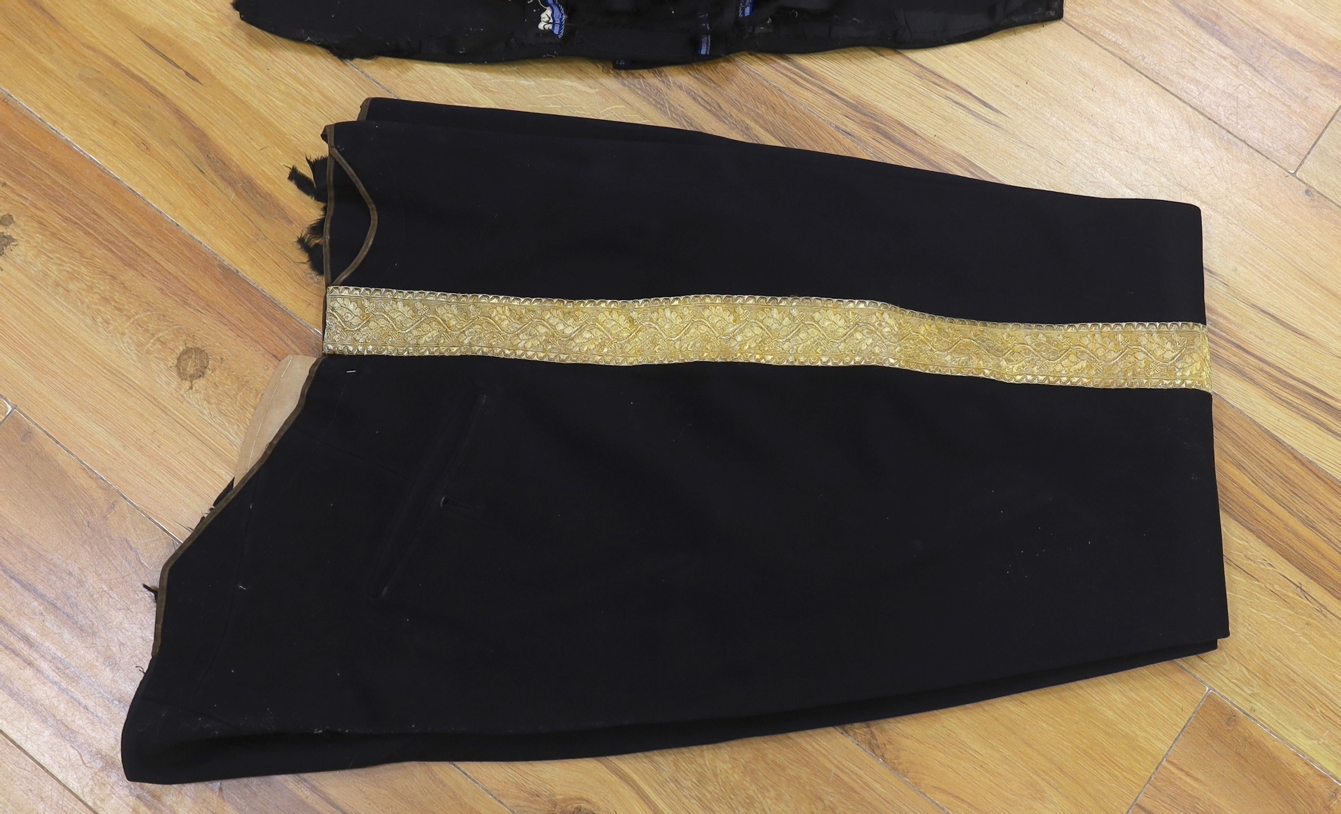 A military black wool dress uniform, with gold decorative braiding